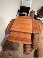 Top view with two leaves extended showing teak grain and leaf mechanism