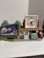 Full view of Coca-Cola diorama clock showing gas station, sign, car, clock