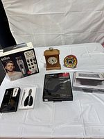Overview showing Braun kit, toenail set, LG headset, two clocks and weather station