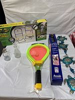Full lot showing ladderball box, badminton rackets, flags pack, sea turtle wind chime