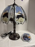 Full view of touch lamp with eagle and wolf panels and spare lighthouse panel displayed