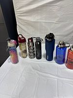 Seven assorted bottles lined on table