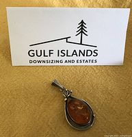 Front view of amber and silver pendant