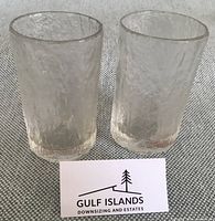 Pair of textured clear drinking glasses standing upright