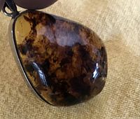 Front view of silver bezel amber pendant