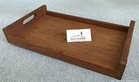 Top view of teak serving tray showing raised sides and handle cut-out