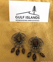 Front view of both earrings showing filigree design, amber stones, and hooks