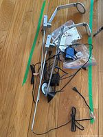 Overview of two silver LED task lights, power supply, mounting hardware bags