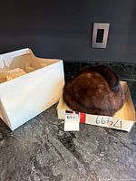 Hat beside storage box on countertop