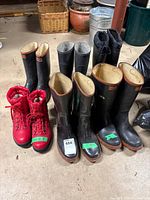 Group of six pairs of boots on floor