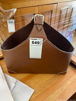 Front view showing faux leather, buckle, stitching, MaxSold tag