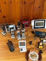 Overall lot view showing phones, radios, weather displays, clock, cables
