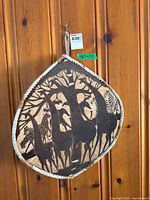 Front of leather shield showing giraffe carving and rope edge