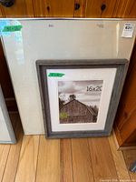 Both frames standing against wood panel wall