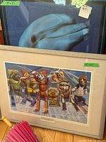 Both framed artworks and parasol visible