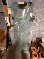 Both glass shower doors standing upright with hinges attached