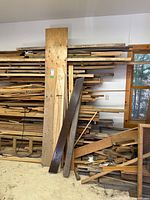 wall rack with stacked hardwood planks of various sizes