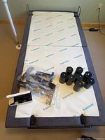 Top view of adjustable bed base with legs and hardware on platform