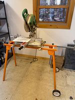 Full view of miter saw on stand in workshop