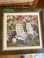 Framed painting showing entire artwork, chairs and flowers visible