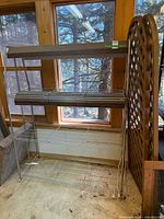 Full view of shelving unit with lattice panel leaning beside it