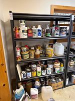 Full view of black metal shelving unit with contents (not included)