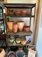 Full view of black metal shelving with four shelves