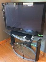 Front view of Pioneer Elite plasma TV on stand with cables