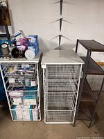 overall view of two white drawer units, metal shelf and bulb boxes