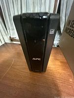 Front view of APC tower UPS showing logo and control panel