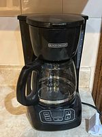 Front view showing complete coffee maker with carafe and control panel