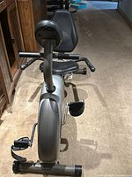 Front view of recumbent bike showing console, seat, pedals