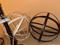Black and white metal orbs side by side