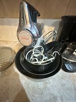 Overall view of Sunbeam stand mixer with stacked bowls, beaters and dough hooks