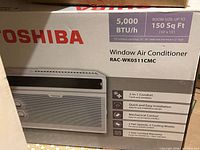 Front of sealed retail box showing Toshiba branding, model and unit image