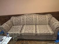 Three-seat sofa front view showing fabric pattern and removable cushions