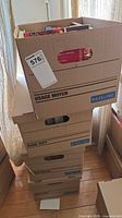 Stacked moving boxes containing books
