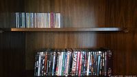 Two shelves showing full assortment of DVD and CD spines