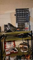 Shelf with circular saw, parts organizer, drill bit, hammer and small boxes