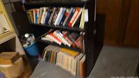 Front view showing bookshelf filled with books