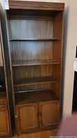 Full view of the brown wood veneer bookcase