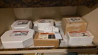 Shelf view of six Duncan plaster molds and boxes