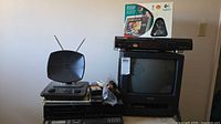 Stack showing Genexxa TV-VCR, Sanyo Beta deck, Logitech QuickCam box, antenna