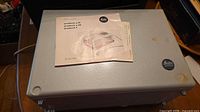 Projector top surface with Leitz badges and instruction manual on top