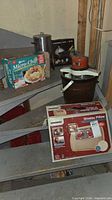 Overall lot with boxed chip maker, ice cream maker bucket and massage pillow box visible