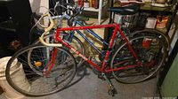 Side view of both bicycles leaning against shelving