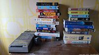 Lot overview showing Realistic rewinder and two stacks of VHS tapes
