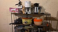 Shelving with coffee makers, chopper box, cookware, crock-pot and jars
