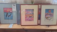 All four framed Ted Harrison prints on shelf