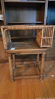 Full view of wood table with wicker shelf placed on top